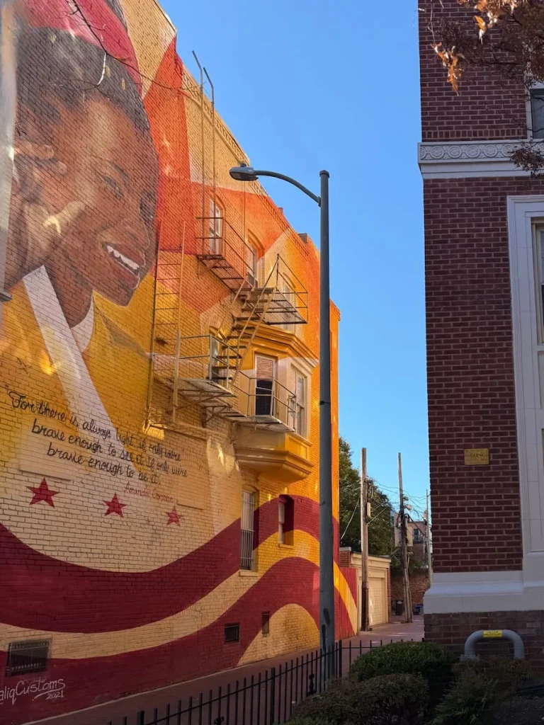 Amanda Gorman Street Art, Dupont Circle, Washington DC. It's painted on the side of a building in reds, ornages and