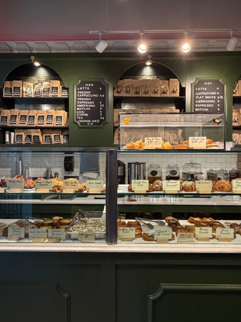 Bakery counter at Soleluna, Washington DC. A counter full of sweet cakes, pastries and savouries, breads arranged beautifully in the counter of this bakery in Adam's Morgan, Washington DC