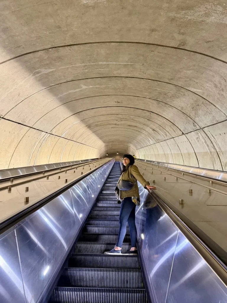 Bejal on steep Metro escalator with white tubular design in Washington DC