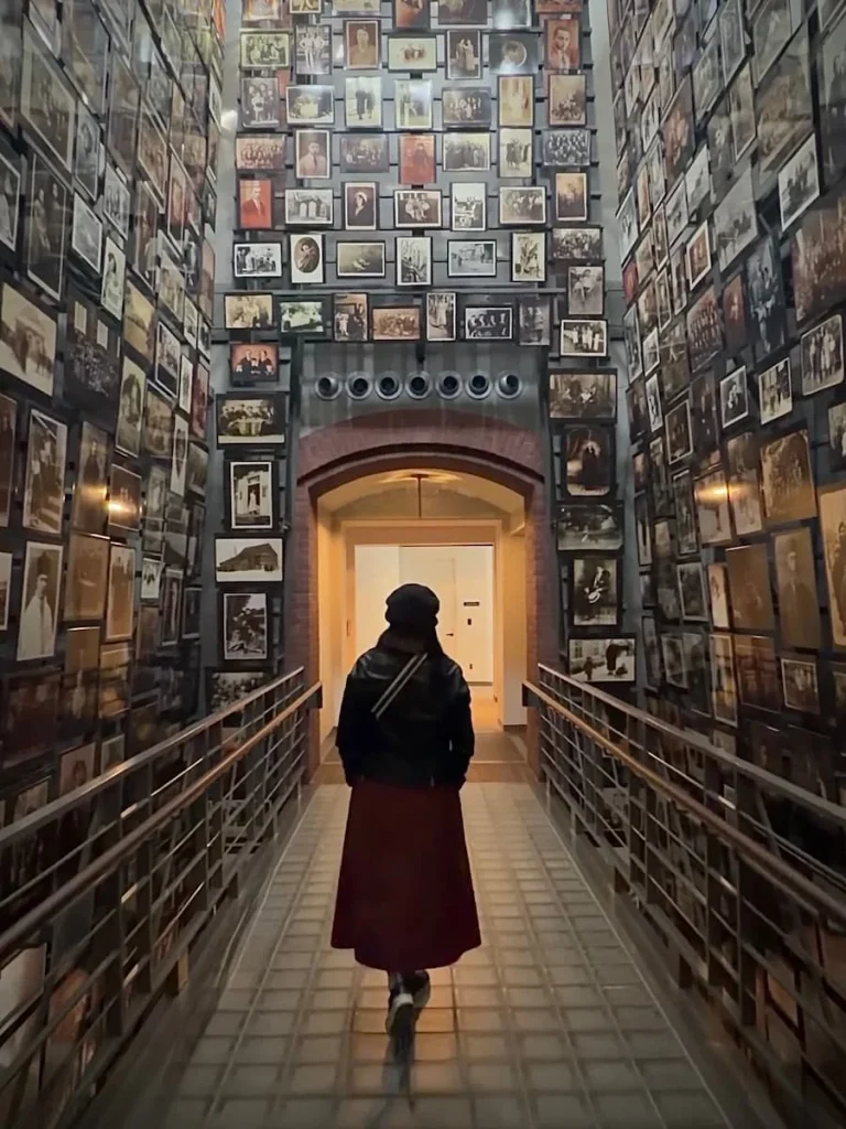 Bejal walking through floor to ceiling photo archway at Holocaust Museum, Washington DC