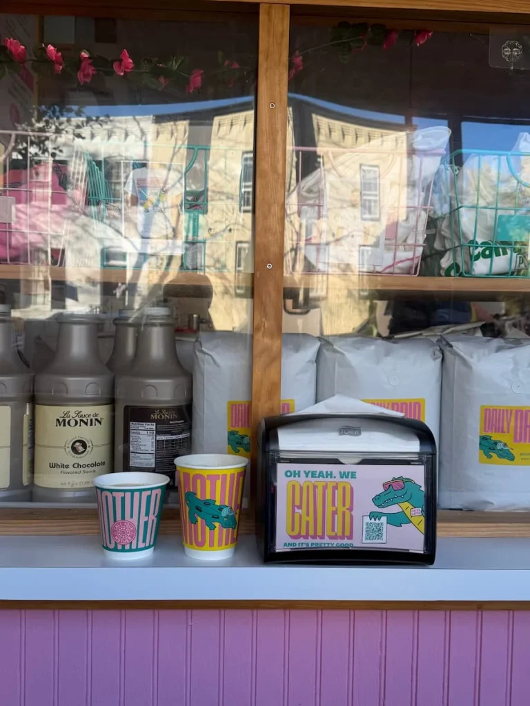 How to spend One day in Georgetown Washington DC. Call Your Mother coffee paper cups on a pink counter, Washington DC. The paper cups have a cool message written on them as does the napkin dispenser.
