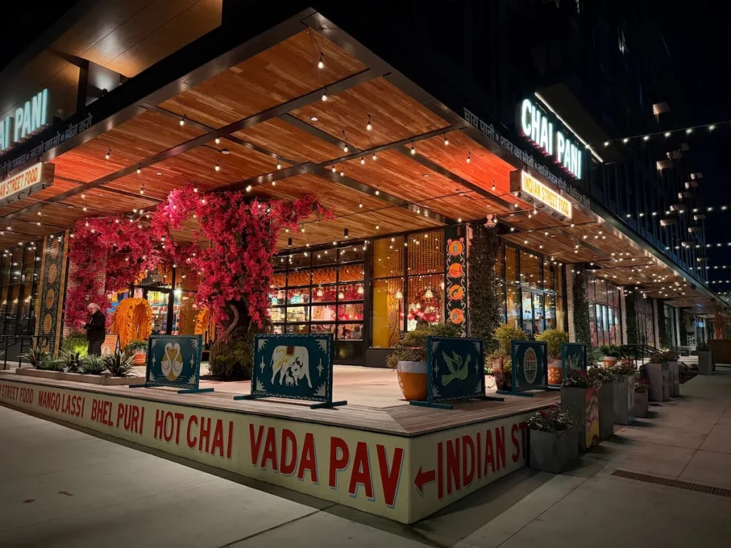 Chai Pani exterior, bright lights, orange, yellow and cerise pink decor, Washington DC