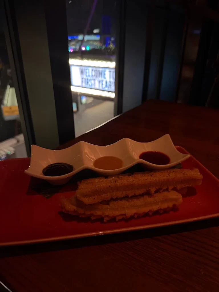 Churros and sauces at Mi Vida, Washington DC with view of District Wharf in the background