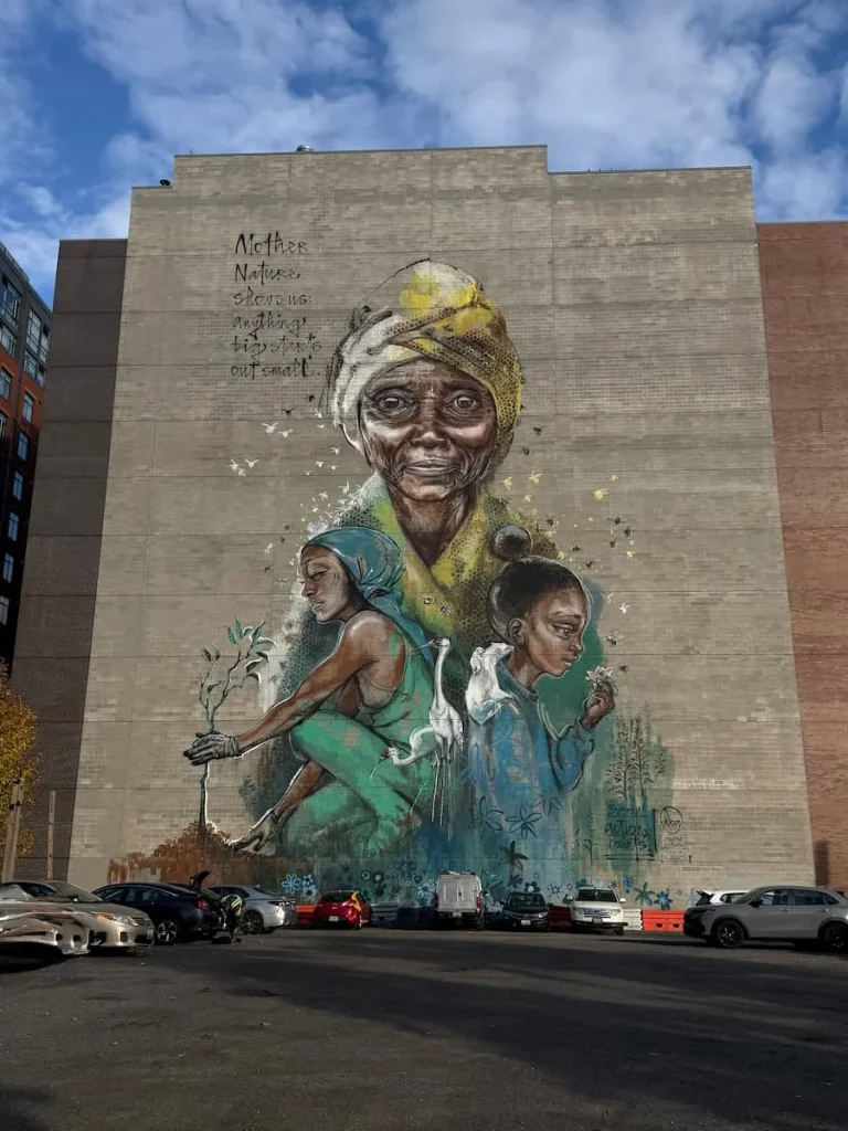 Women in Climate Action Mural, Washington DC with a women at it's centre point in a car parking lot