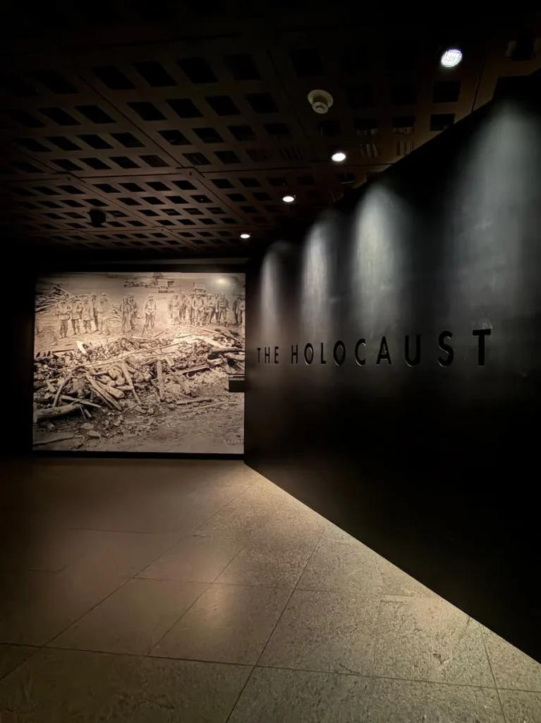 Entrance into the Holocaust Museum, Washington DC with image of deceased bodies adn black wall with 'The Holocoast' lettering