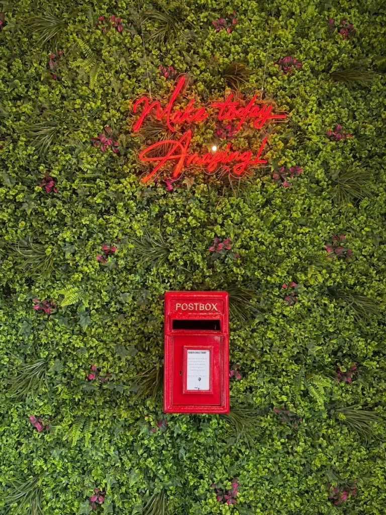 Make today Amazing red neon sign at Mamma Dos with a red post box fascia on an artificial grass background Washington DC