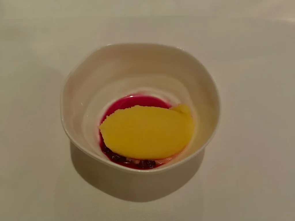 Palate Cleanser of grapefruit and fermented dragon fruit at in a small white bowl on a crisp white tablecloth Elizabeths, Washington DC