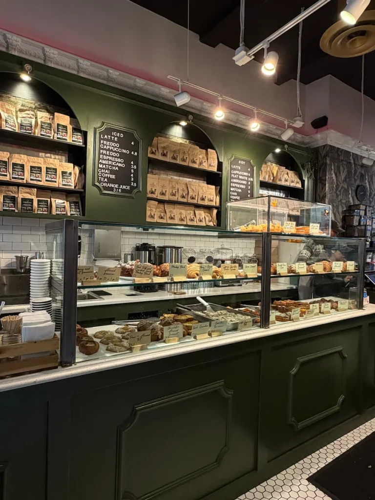 A side view of the Bakery counter at Soleluna, Washington DC. A counter full of sweet cakes, pastries and savouries, breads arranged beautifully in the counter of this bakery in Adam's Morgan, Washington DC