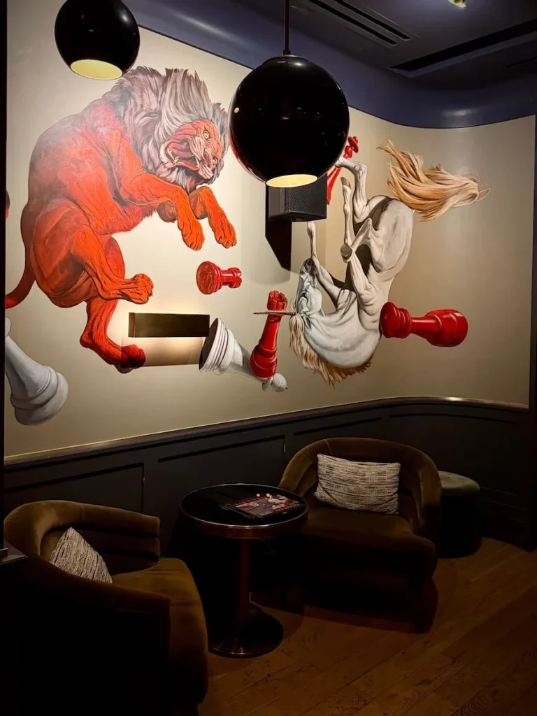 Wallpaper along one side of bar depicting Ruby Bridges at Allegory, Washington DC