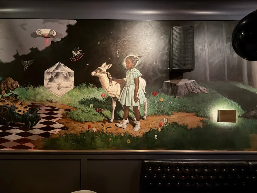 Mural along one side of bar depicting Ruby Bridges at Allegory, Washington DC.