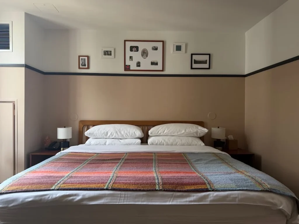 Bed with blanket at Eaton DC Washington DC. There is a red and grey blanket on the white sheets of thebed