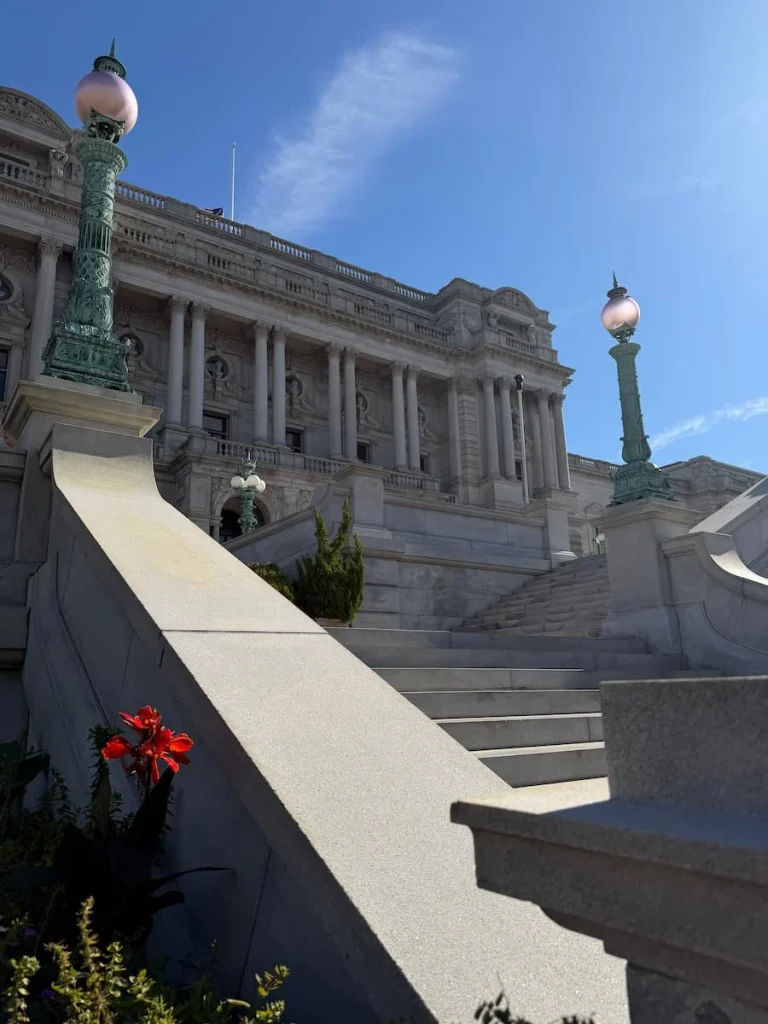 Library of Congress Exterior, Washington DC on a sunny day with blue skies and the stone pillars of the entrance