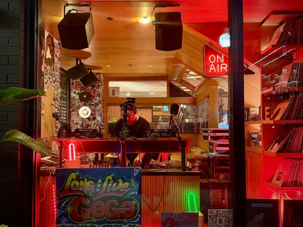 Radio Station at Eaton DC, Washington DC. Station can be seen from outer window with a DJ in the window and with records and red lighting