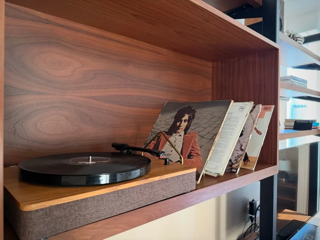 Record player in room with vinyl records at Eaton DC, Washington DC on a brown wooden shelf. There is a Micheal Jackson vinyl in the background