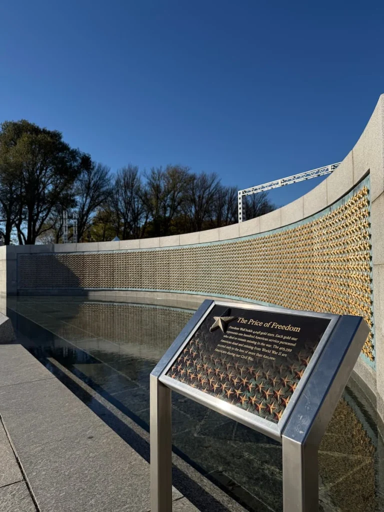 The Price of Freedom wall, Washington DC with gold stars adn a water feature in the front