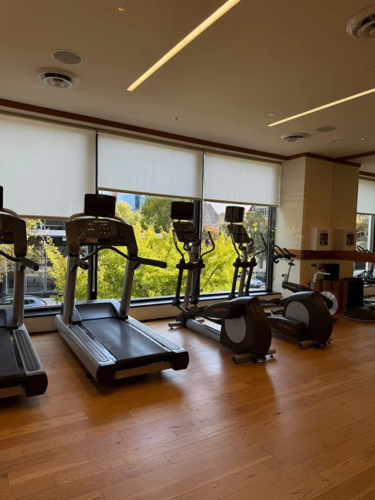 Treadmills and gym equipment at Eaton DC, Washington DC, arranged in a row looking out towards the window