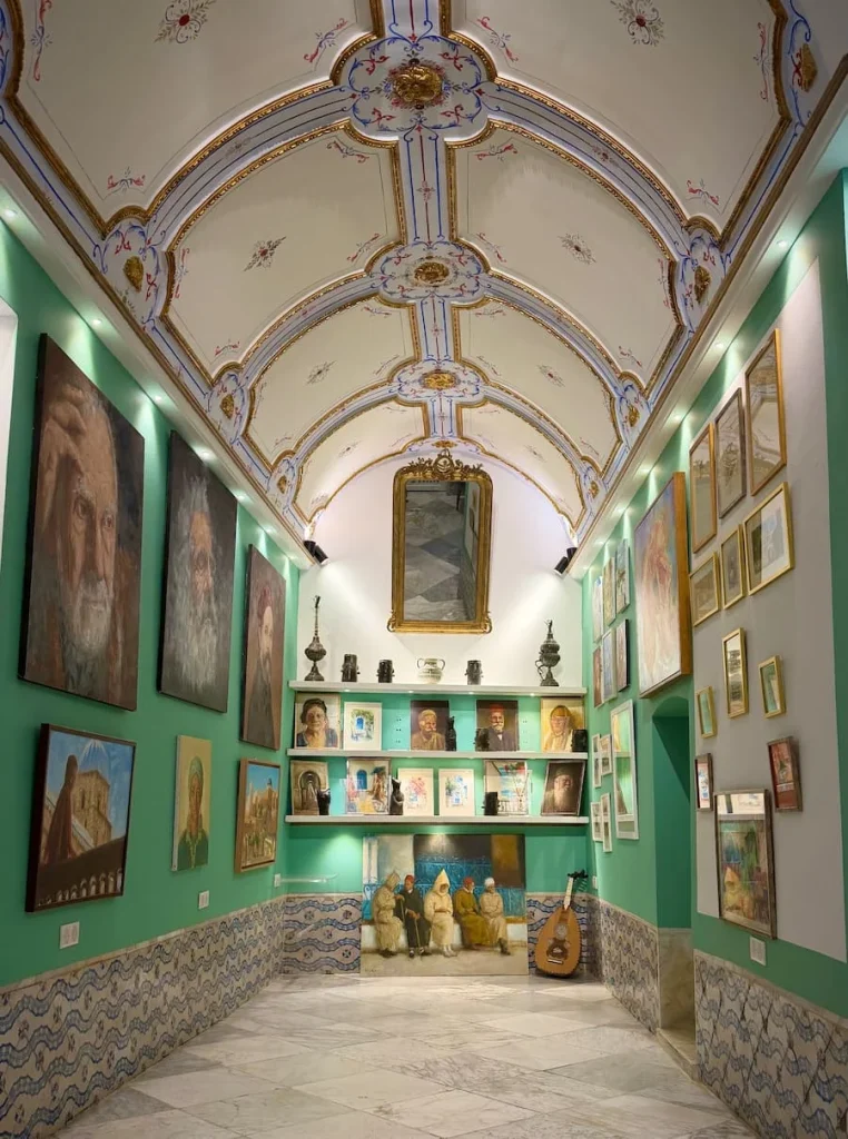 The vaulted white and mint green interiors with artworks inside Aly C Gallery, Sid Bou Said, Tunisia