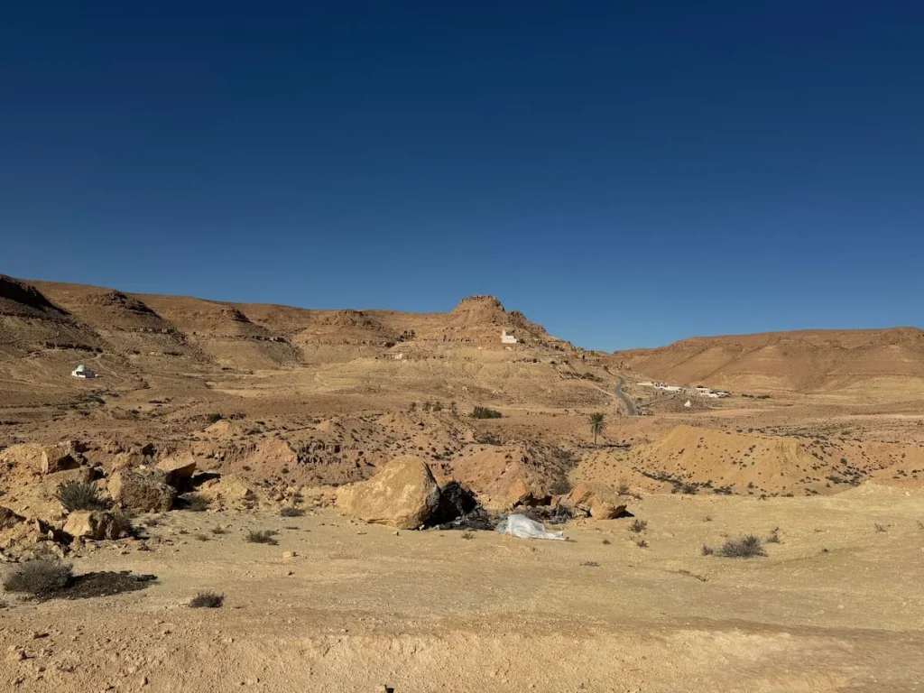 A distance panorama of the Berber town Douiret, Tunisia. There is a small white church that's noticeable as the rest of the village has crumbled adn there are no residents