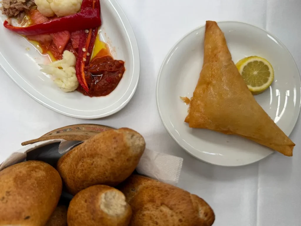 BriK at Fondouk el Attarine, Tunis Medina, Tunisia. A top lay featuring a triangular brik, bread and peppers with harissa