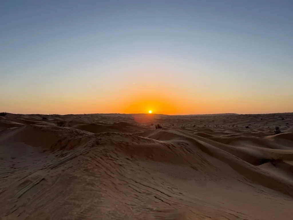 Sunrise in the desert with sand dunes all around at Camp Abdelmoula, Tunisia