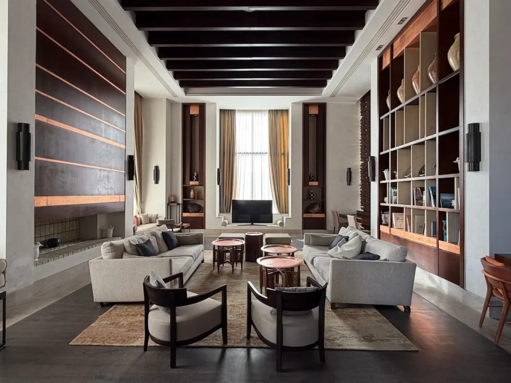 Communal lounge area in the main part of The Mora Tozeur. There are sofas, side boards, books, soft furnishings and ornaments