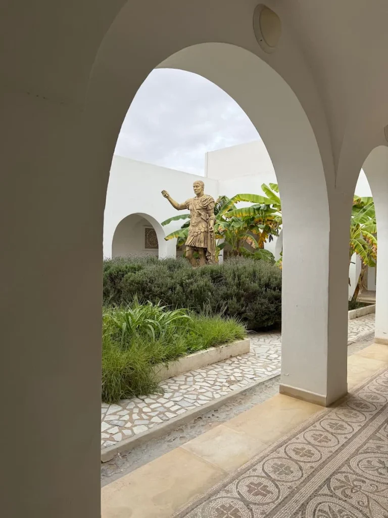 El Djem Archaeological Museum, archways, Tunisia. The white arches open up onto a courtyard garden with a bronze statue