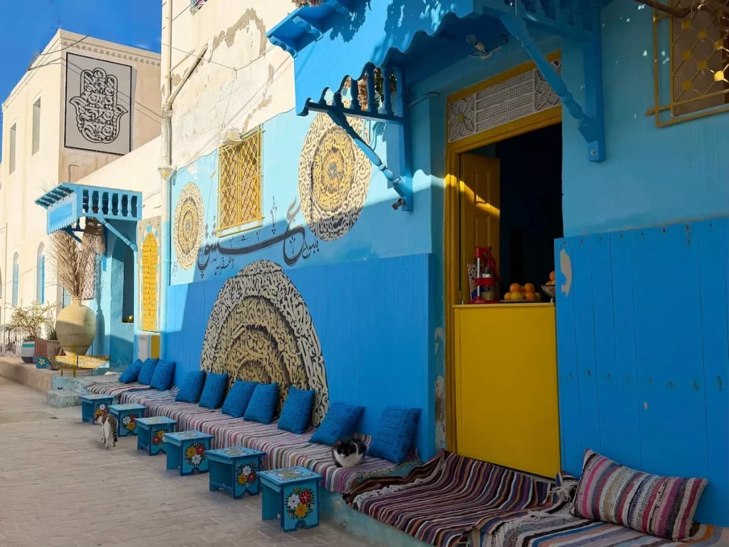 A row of blue and yellow Erriadh cafes in Djerba