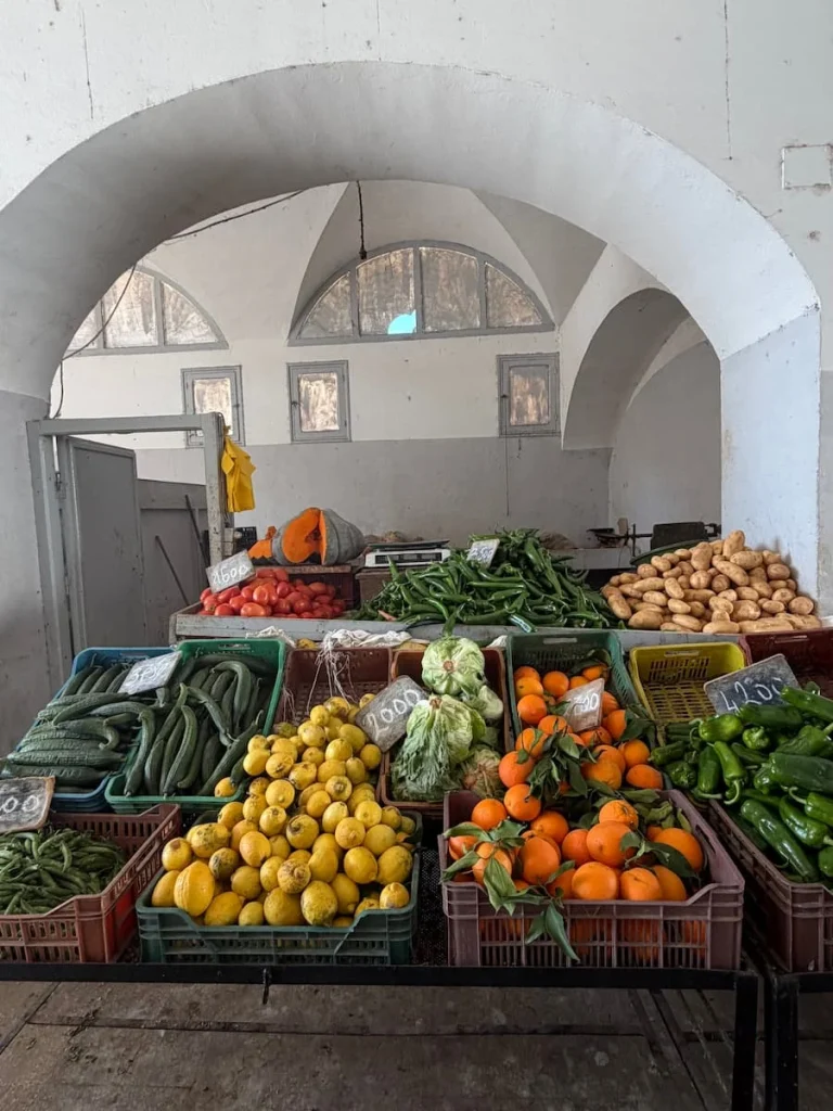 A fruit and vegetable stall in Houmt Souk, Djerba. The druit and vegetables are all laid out on a table with varying slants