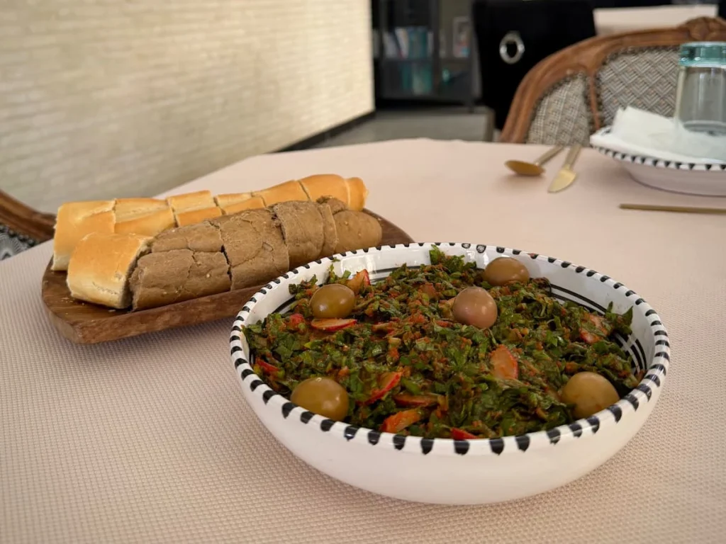 Grilled vegetable salad called Ojja, Tunisia. Vegetables include, onions, peppers, broccoli, courgettes and tomatoes with olives.