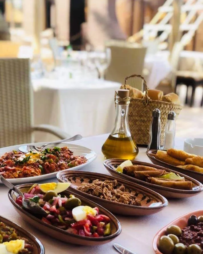 Haroun Restaurant with a medley of food on clay platters and olive oil, Djerba