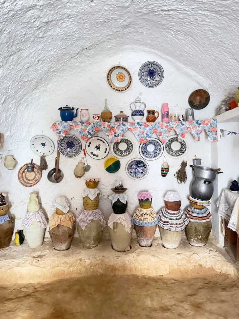 colourful Hanging clay plates, pots, teapots inside a Troglodyte House in Matmata.