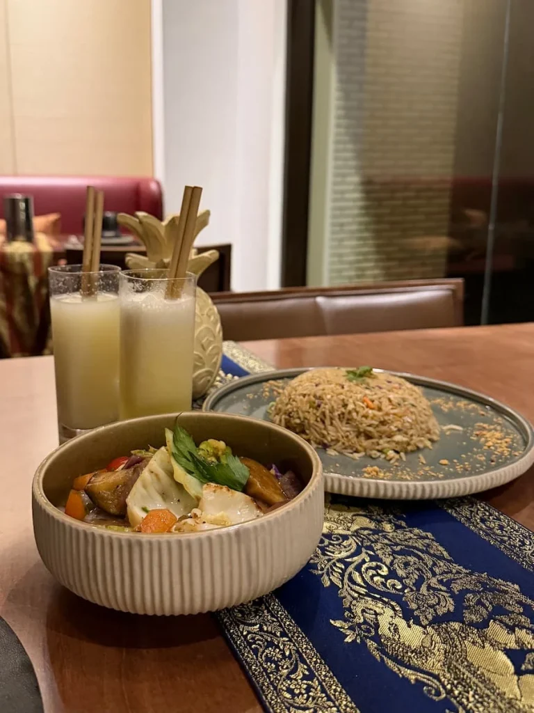 Mekong at The Mora Asian restaurant, Tunisia. A bowl of vegetables and fried rice with fresh pineapple juices in the background in Tozeur