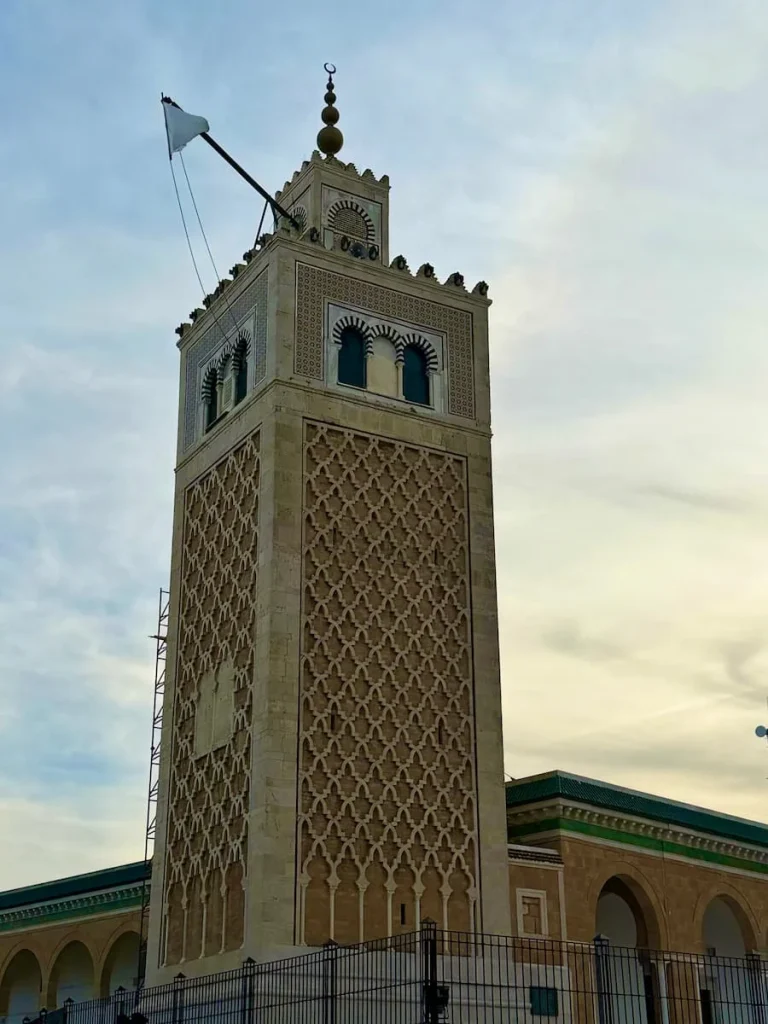 Luxury 14 day Tunisia itinerary Minuret of Tunis Medina, Tunisia. The Minuret has a white top and diamond shaped white tan and blue design