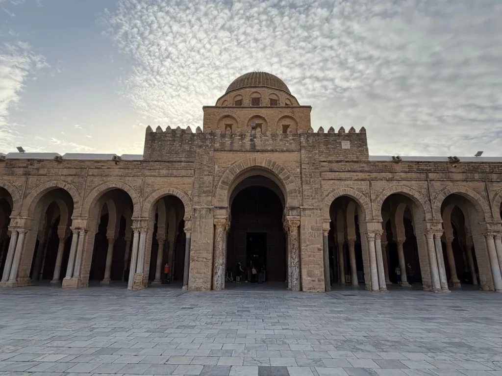 Mosque of Okba courtyard, Kairouan, Tunisia with stone structure against a early morning sky