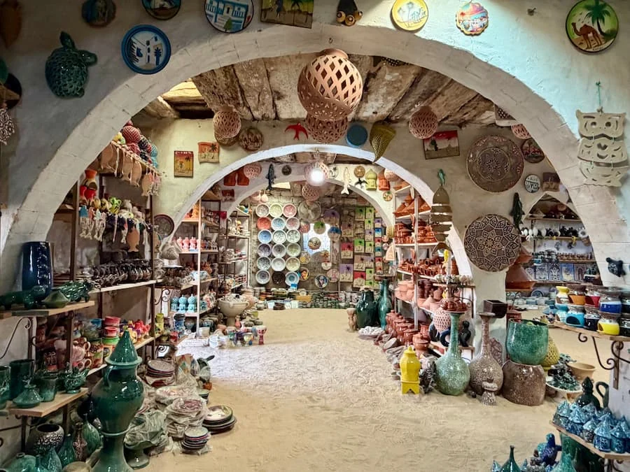 colourful interiors of Pottery store with plates, bowls and vases filling the showroom located in Guellala, Djerba, Tunisia