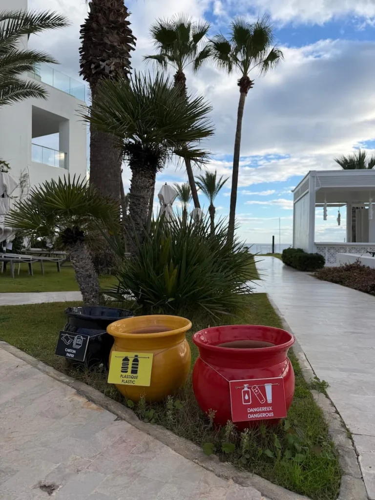 Recycling pots at La Badira, Hammamet. The pots are yellow, green and red and have labels on to distinguish which items to place in them