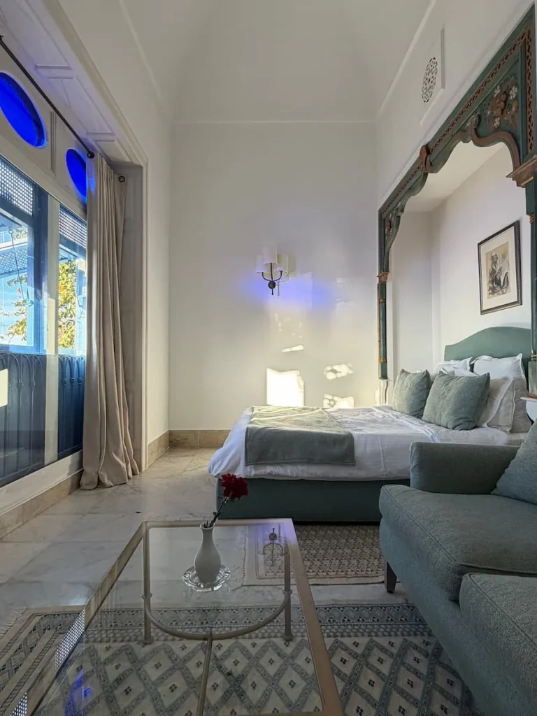Sea view Room, Dar Said. Ther linens are white with pale green sofas and bedspreads. Sidi Bou Said, Tunisia