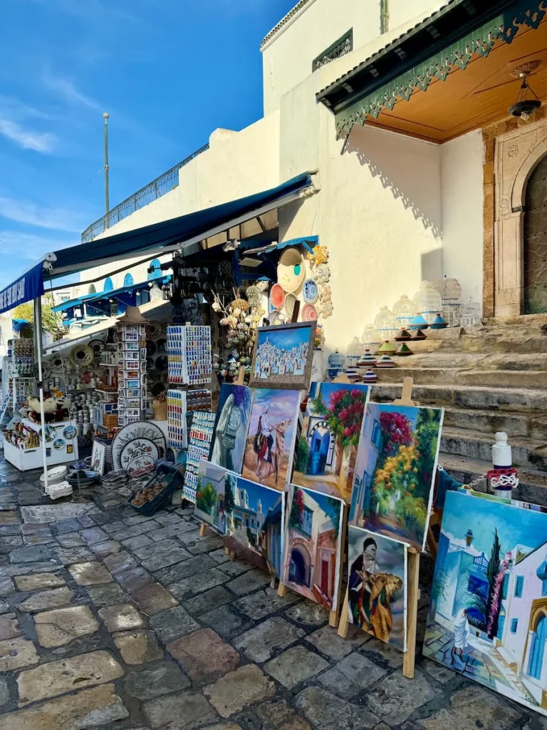 Sidi Bou Said watercolour stalls, Tunisia. The stalls are lined up on a cobbled-stone street