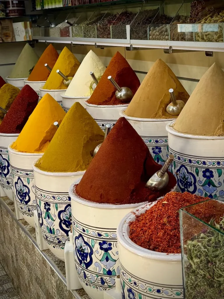 colourful Spices arranged in a triangular peak at Djerba market. The spices are in blue and white traditional pottery containers