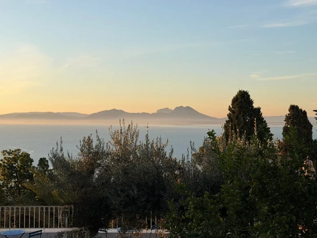 A view of the mist adn sun rise from Dar Said , room with a sea view, The foliage, trees and bushes are partially covering the mountain misty views