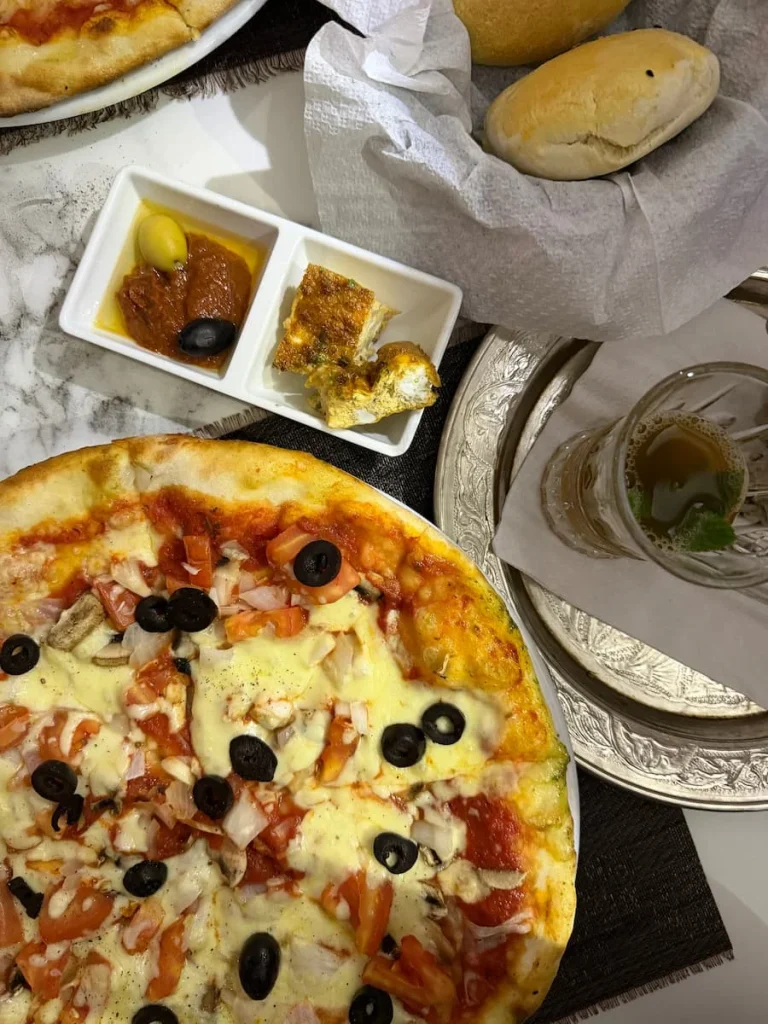 Top lay of a Tunisian Pizza and sides at Blu Blu, Sidi Bou Said, Tunisia