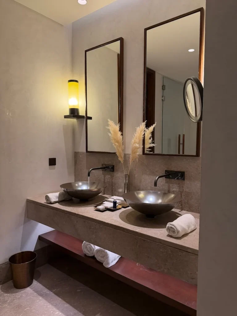 Vanity unit at The Mora, Tozeur. There are two basins with toiletries, towels and soaps