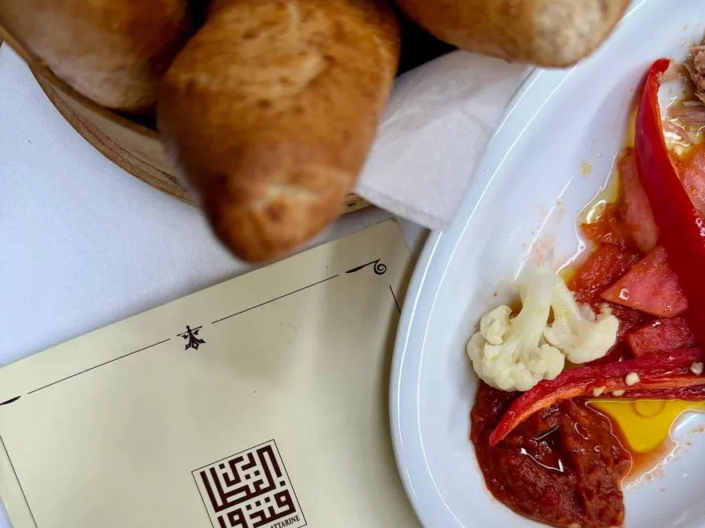 Bread and table snacks such as red pepper, cauliflower and olives at Fondouk el Attarine, Tunis Medina