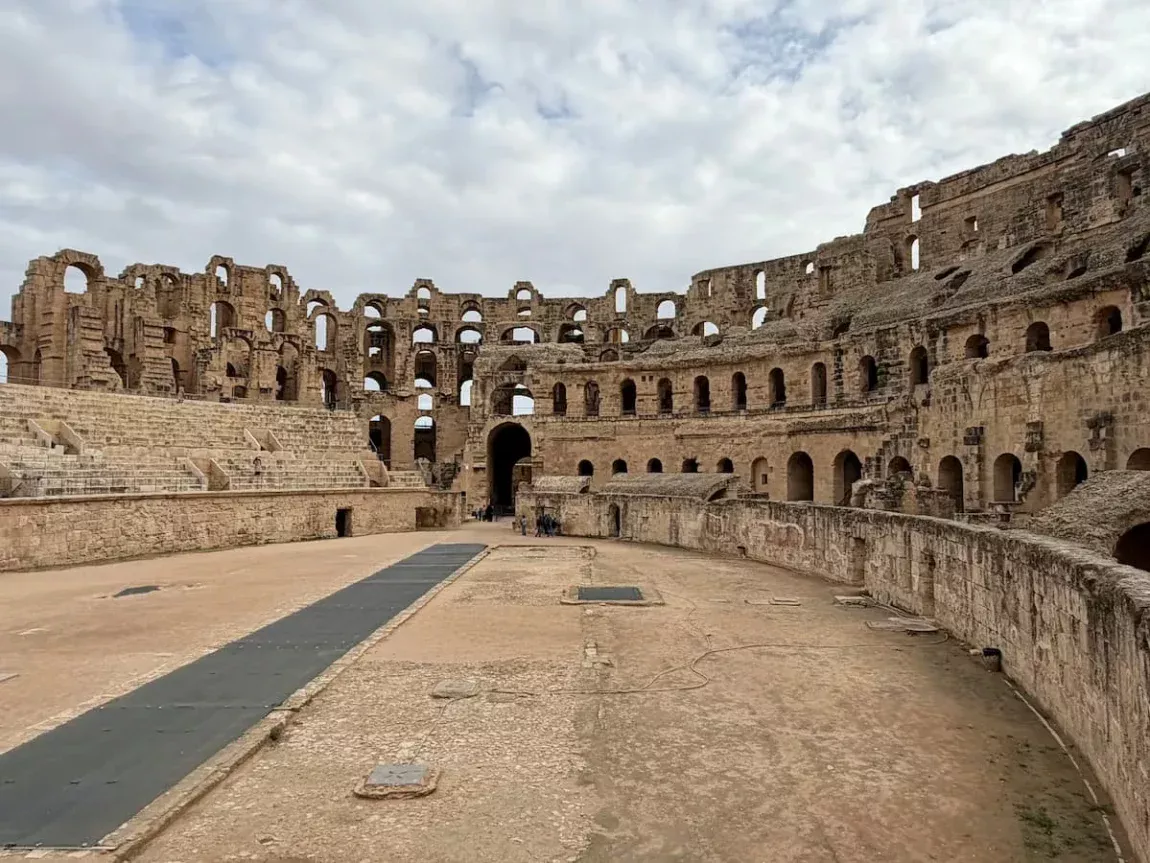 El Djem Amphitheatre Interior. Tunisia. The structure is a colosseum with a walkway in the middle and thousands of seats surrounding in a circlular design