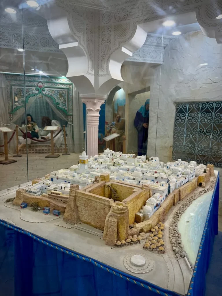 Kasbah and Medina model inside Khadija museum, Hammamet. There are other artefacts in the background including statues of traditional dress