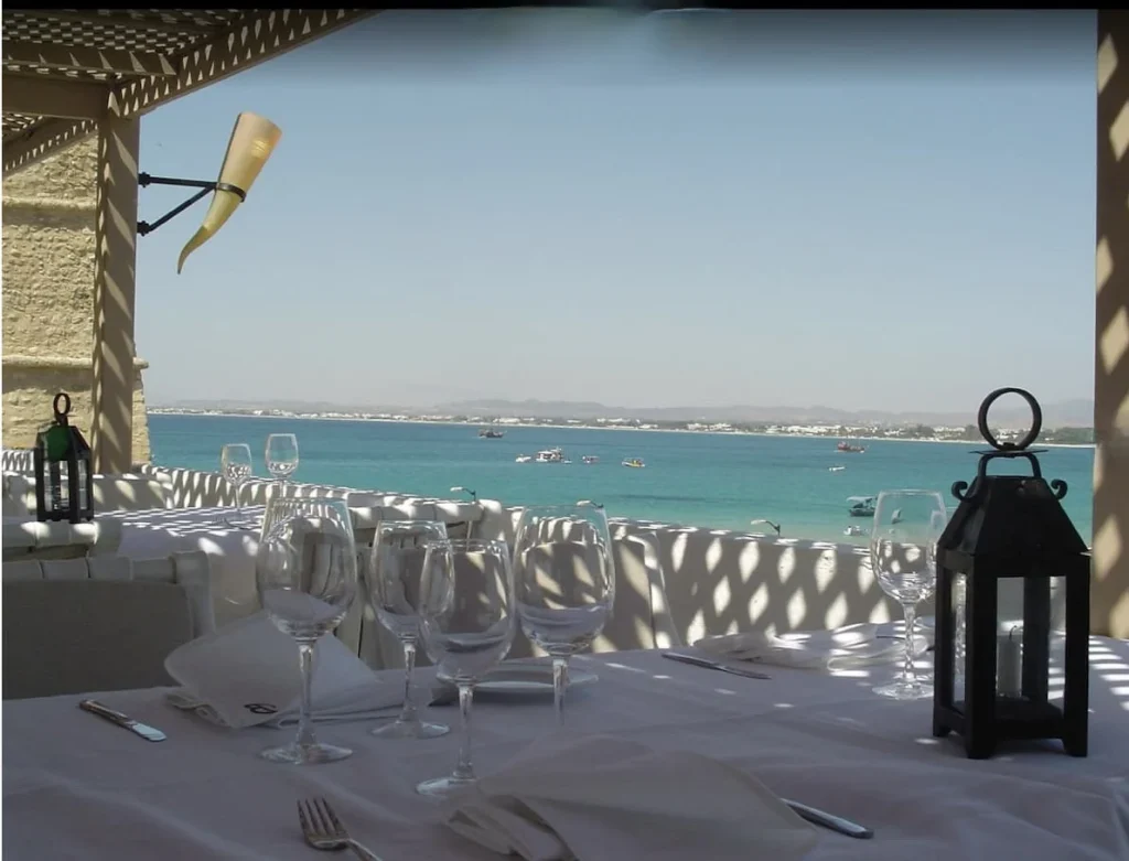 The view from the Le Barberousse window from their restaurant in the Kasbah. The table is set with turquoise waters in the background
