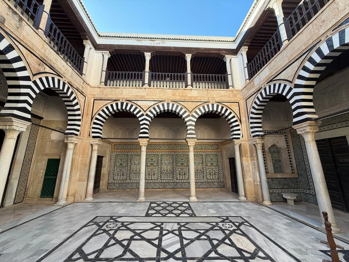 Things to do in Kairouan. The Mausoleum of Sidi Sahbi interiors with the the Andalusian style tiles adn arches.